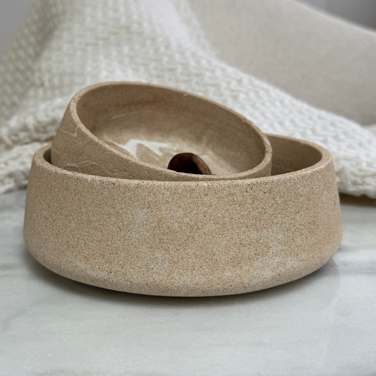 Handcrafted Dune Bowls in two sizes, nested together to highlight their textured stone-inspired finish.