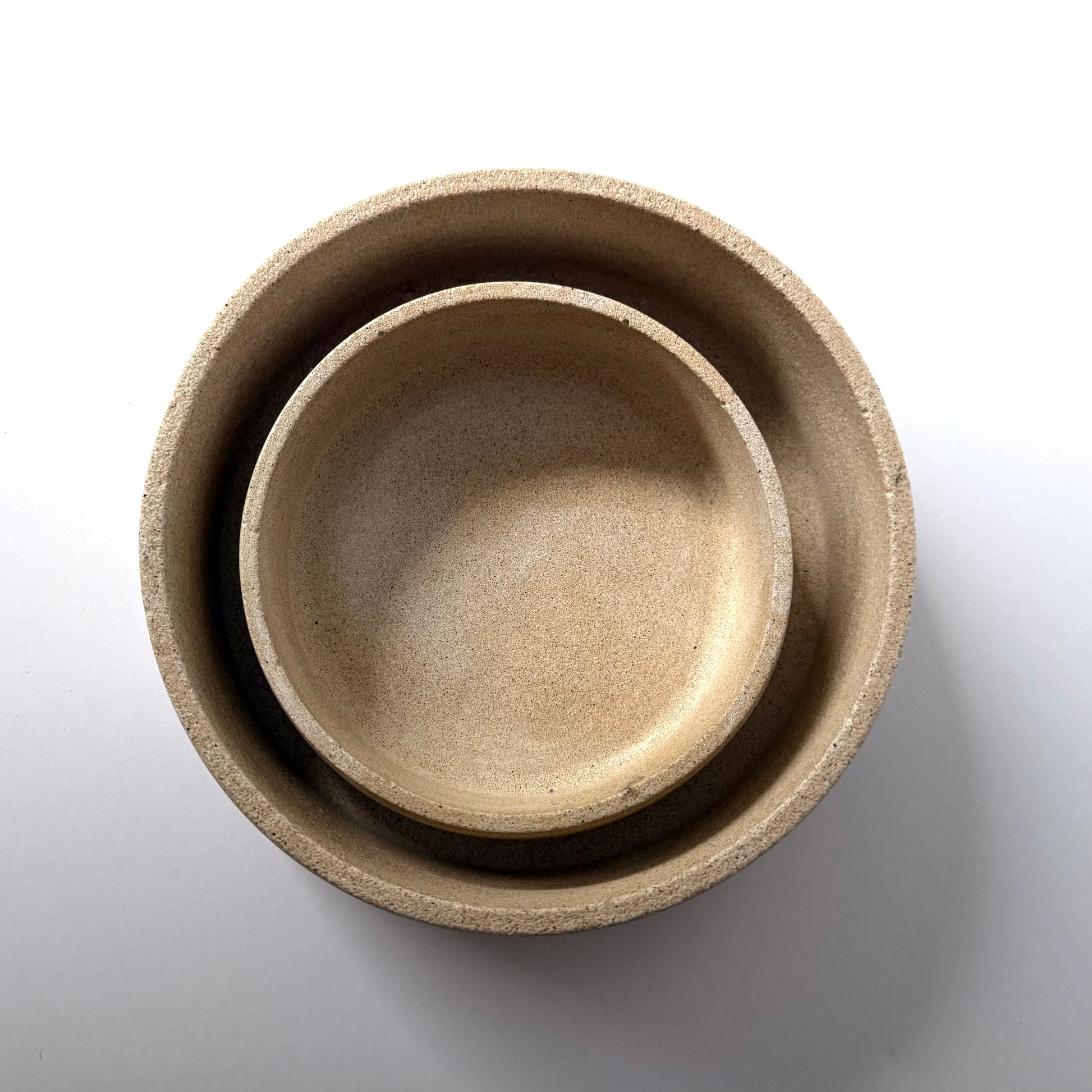 An overhead view of two handcrafted Dune Bowls, to highlight their shape and textured stone-inspired finish.