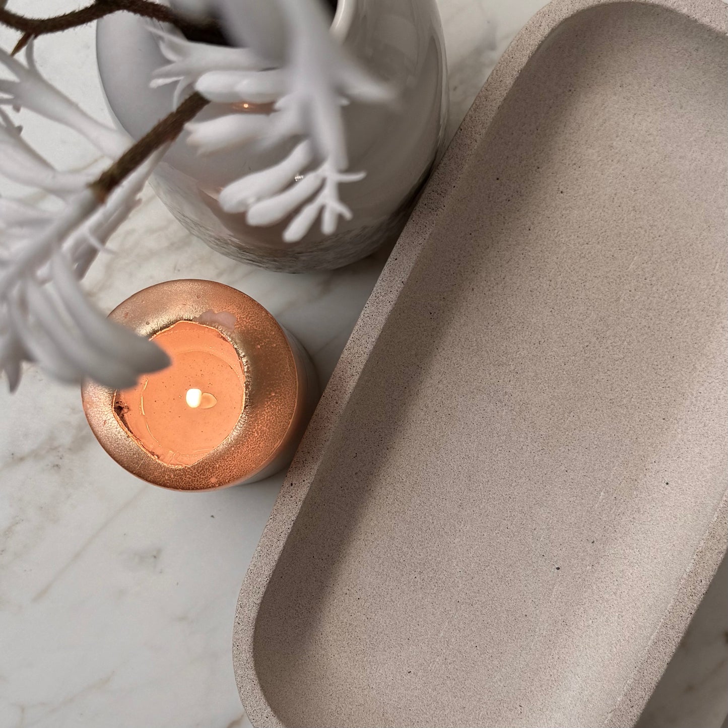 Overhead view of handcrafted Monolith pedestal featuring a solid yet minimalist rectangular form with a natural stone-inspired finish and rounded corners. 