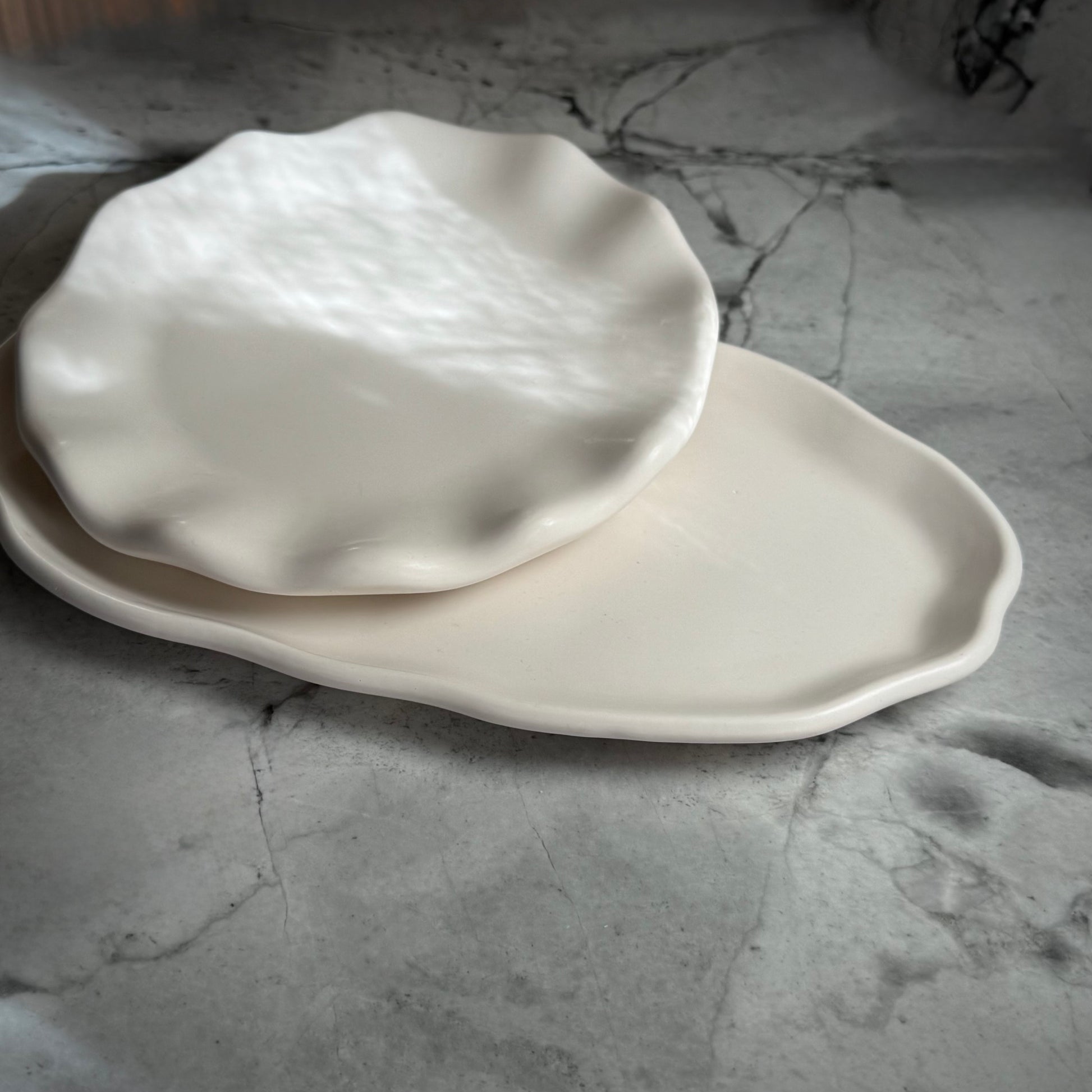 Close up detail view of two stacked Shore Trays showcasing their organic edges and natural stone-inspired finish.