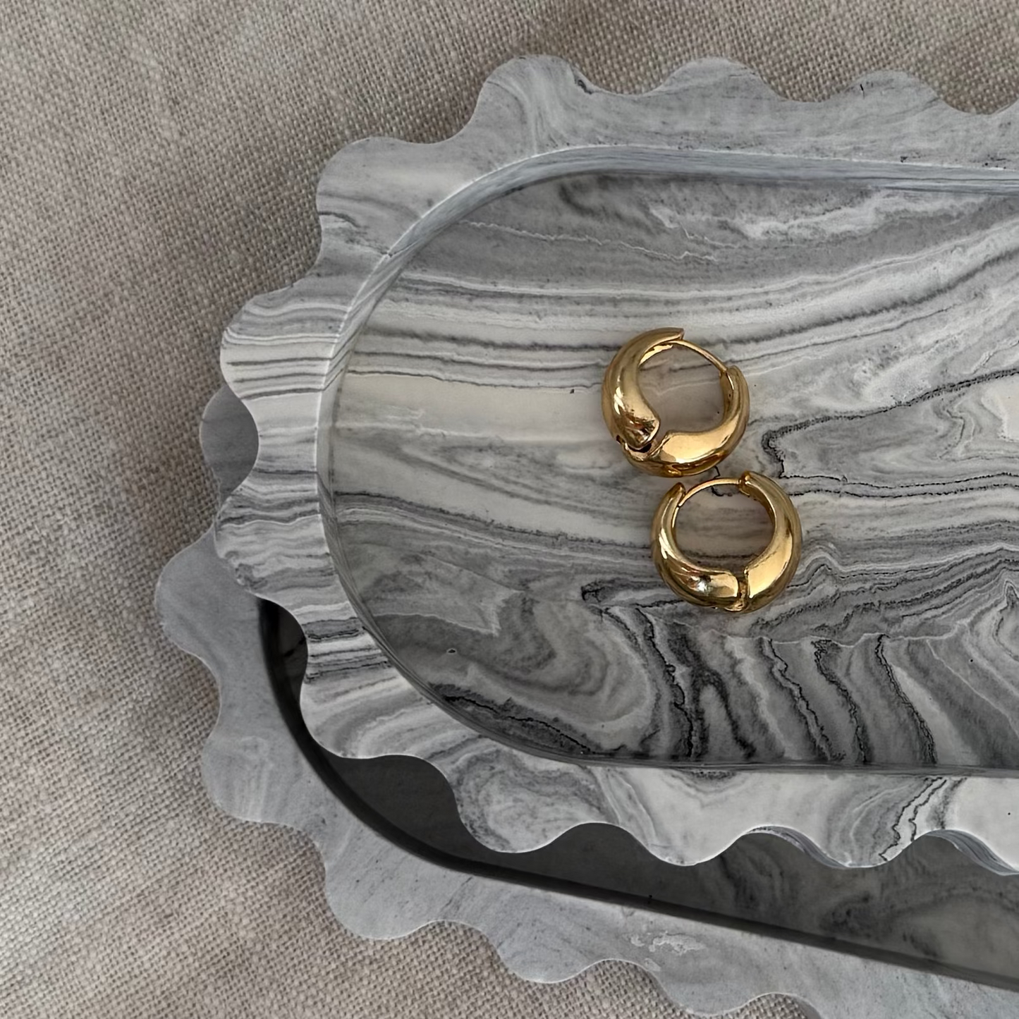 Close up view of two handcrafted Tide Trays highlighting the collection's sculptural silhouette and contrasting finishes.