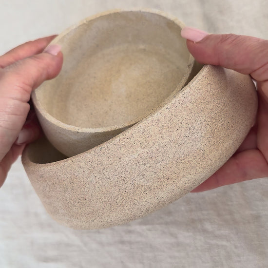 Video showing a set of handcrafted Omora Dune Bowls highlighting their curved form, nested design and stone-inspired textured finish.