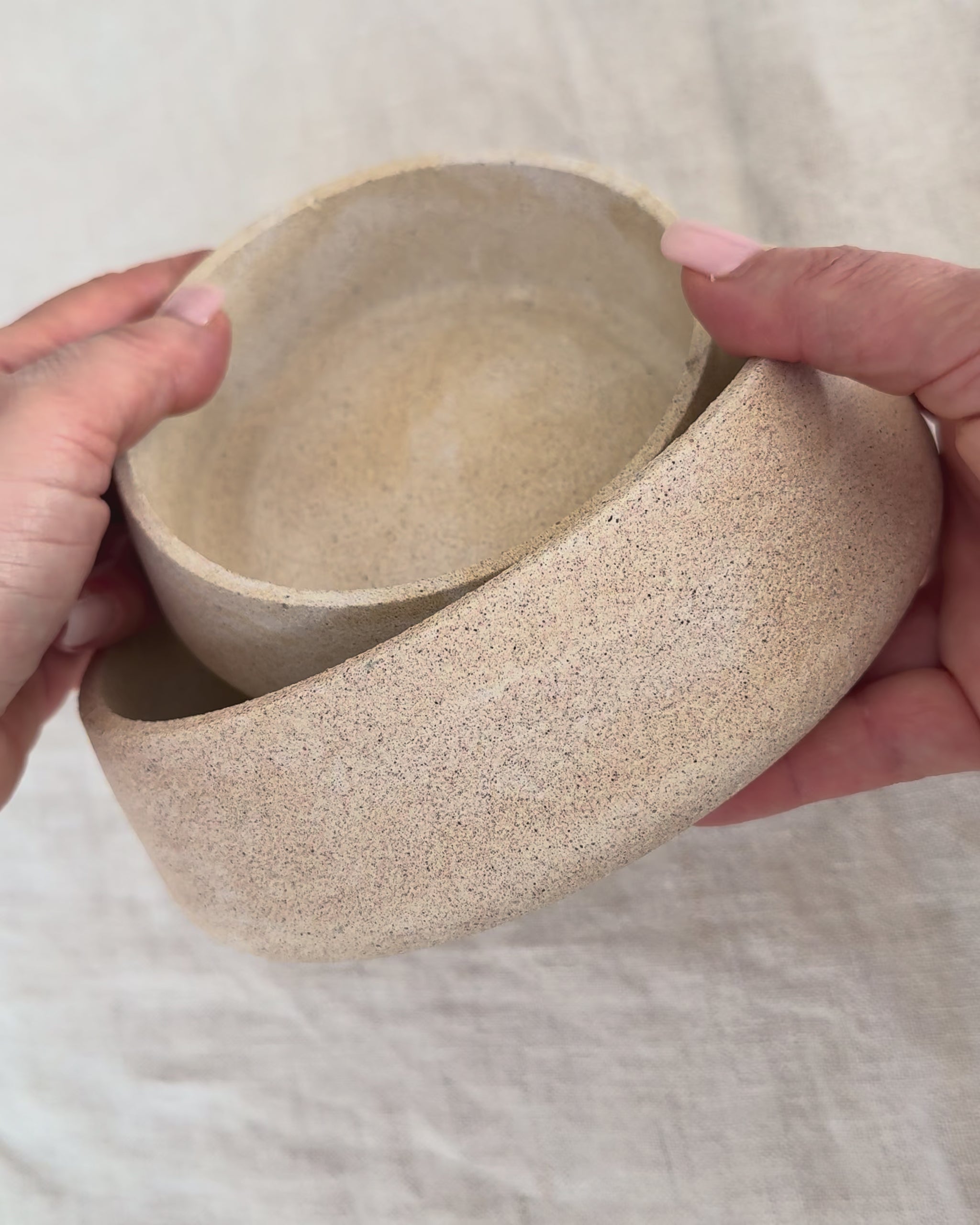 Video showing a set of handcrafted Omora Dune Bowls highlighting their curved form, nested design and stone-inspired textured finish.
